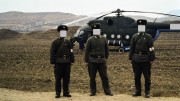 Soldiers guarding our Russian helicopter used to tour gold mines in North Korea in 1993. (Faces covered to hide their identities.) Photo by David Tyrwhitt